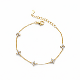 Gold bracelet with star-shaped diamond charms on a white background