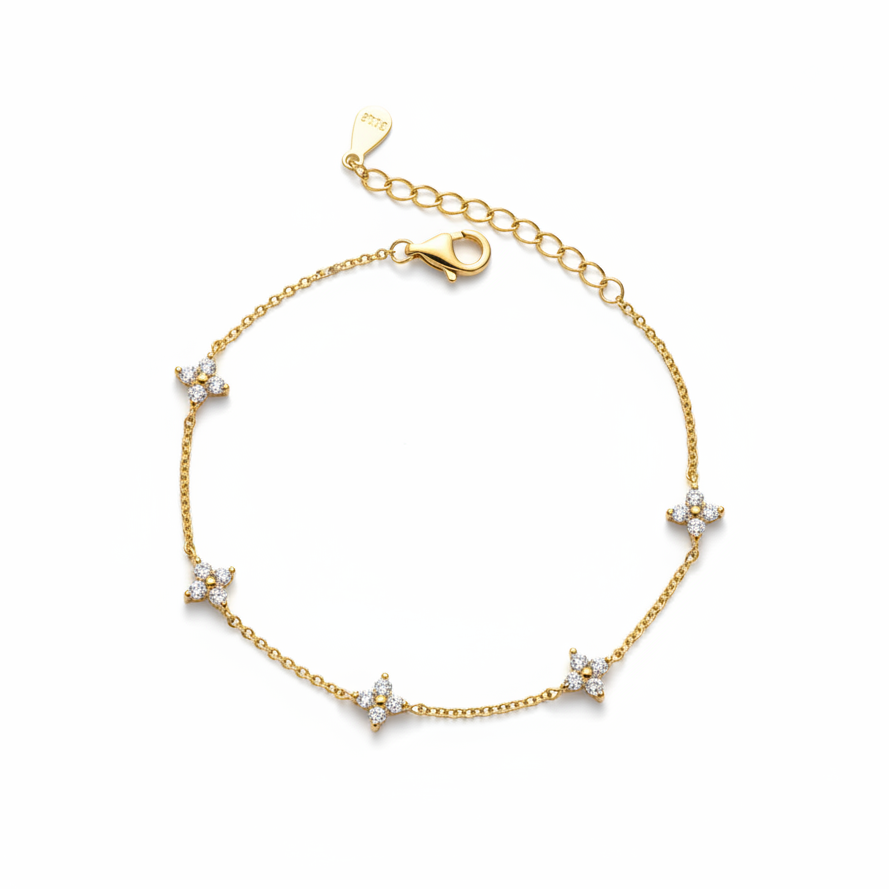 Gold bracelet with star-shaped diamond charms on a white background