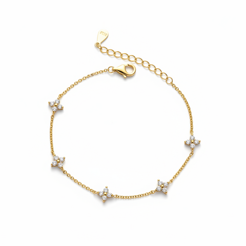 Gold bracelet with star-shaped diamond charms on a white background