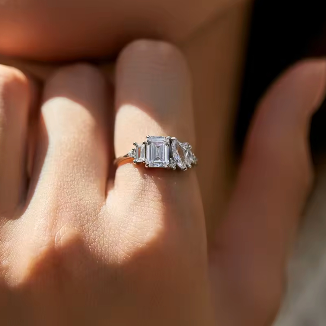 Diamond ring on a person's finger with a blurred background